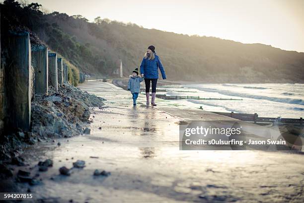 walking with mum at totland bay - isle of wight family stock pictures, royalty-free photos & images