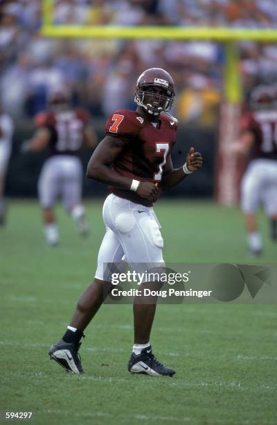 Quarterback Michael Vick of the Virginia Tech Hokies jogs on the field during a game against the Akron Zips at Lane Stadium in Blackburg, Virginia....