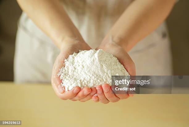 flour on palm of young woman,close up - flour ストックフォトと画像