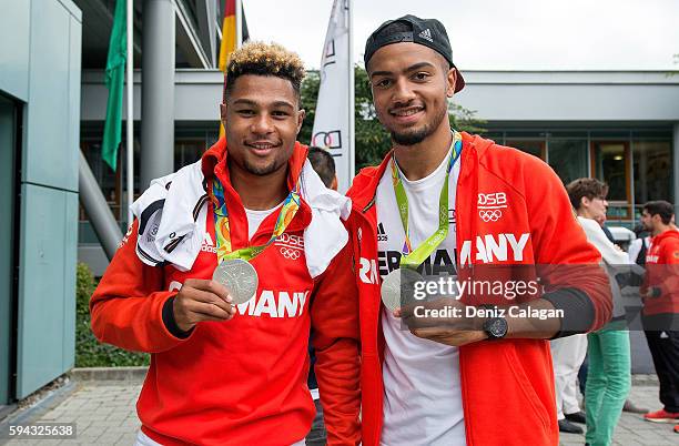 Serge Gnabry and Jeremy Toljan present their silver medals during the German Men's Olympic football team welcome home reception at DFB Headquarter on...