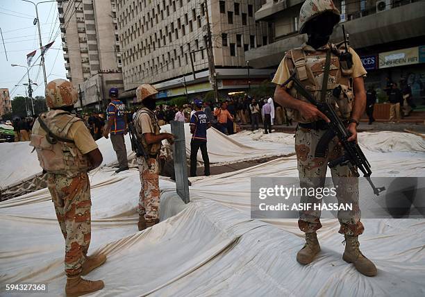 Pakistani paramilitary rangers stand over a demolished hunger strike camp of the Muttahida Qaumi Movement political party following a clash with...