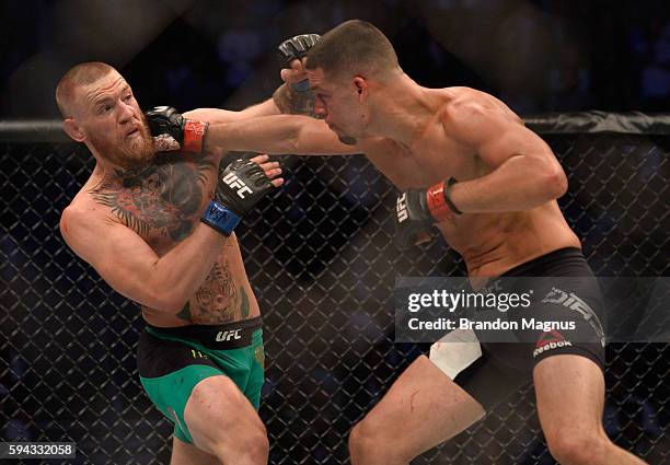 Nate Diaz punches Conor McGregor in their welterweight bout during the UFC 202 event at T-Mobile Arena on August 20, 2016 in Las Vegas, Nevada.
