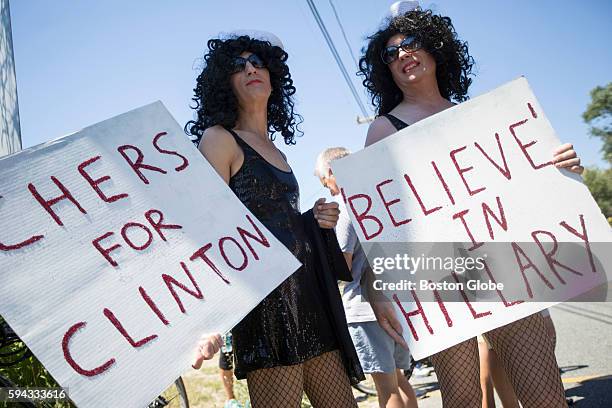 Cher impersonators Steve Turner and Tim Howe hold signs of support for U.S. Presidential candidate Hillary Rodham Clinton across the street from a...