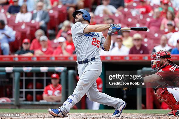 Rob Segedin of the Los Angeles Dodgers hits a sacrifice fly to center to drive in a run in the third inning against the Cincinnati Reds at Great...