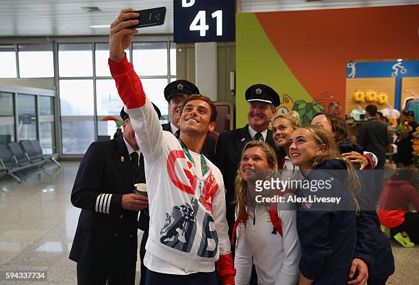 Tom Daley, Tonia Couch and Lois Toulson of Great Britain take a selfie with British Airways Captain Steve Hawkins and his crew as Team GB prepare to...