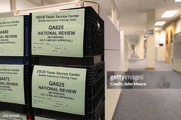 Crates containing immigrants' permanent residency applications await processing at the U.S. Citizenship and Immigration Services , Texas Service...