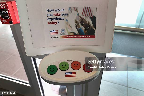 Happiness response monitor awaits immigrants departing the U.S. Citizenship and Immigration Services , Dallas Field Office on August 22, 2016 in...