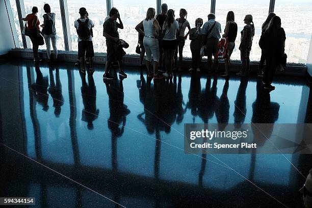 People look out at Manhattan and beyond at One World Observatory at One World Trade Center on August 22, 2016 in New York City.The observation deck...