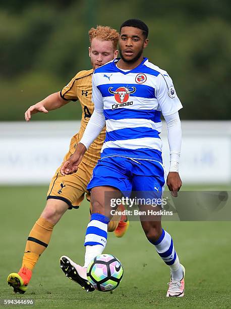 Dominic Samuel of Reading holds off pressure from Connor Ogilvie of Tottenham during the Premier League 2 match between Reading and Tottenham Hotspur...