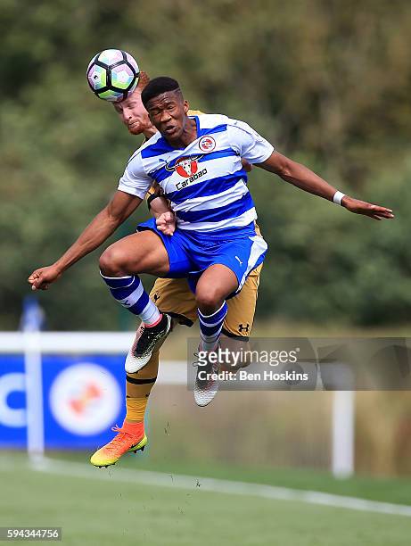 Gabriel Osho of Reading and Connor Ogilvie of Tottenham battle for an aerial ball during the Premier League 2 match between Reading and Tottenham...