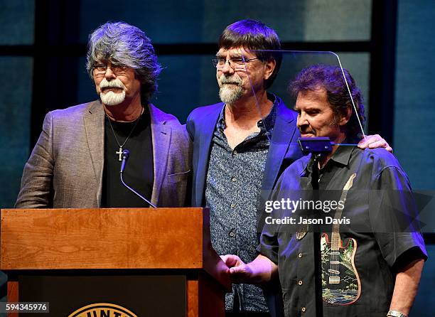 Randy Owen, Teddy Gentry, and Jeff Cook of the band Alabama speak during the debut of the "Alabama: Song of the South" exhibition at Country Music...