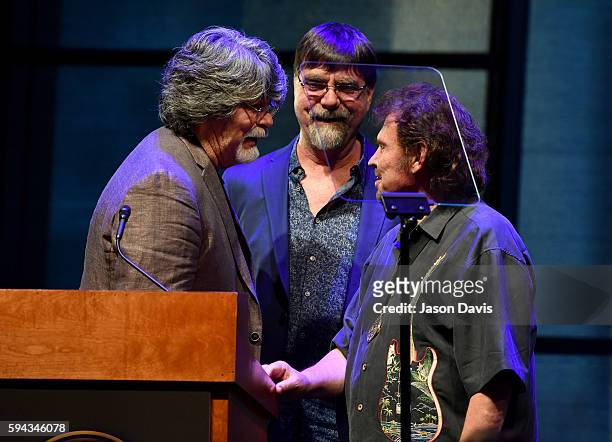Randy Owen, Teddy Gentry, and Jeff Cook of the band Alabama speak during the debut of the "Alabama: Song of the South" exhibition at Country Music...