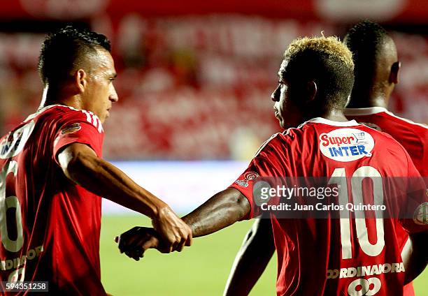 Brayan Angulo of America de Cali celebrates with teammates after scoring the third goal of his team during a match between America de Cali and...