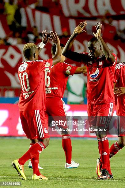 Cristian Martinez Borja of America de Cali celebrates with teammate Brayan Angulo after scoring the opening goal during a match between America de...