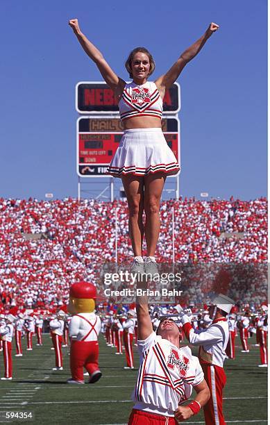 General view of a cheerleader for the Nebraska Cornhuskers being raised up at the half-time show during the game against the San Jose State Spartans...