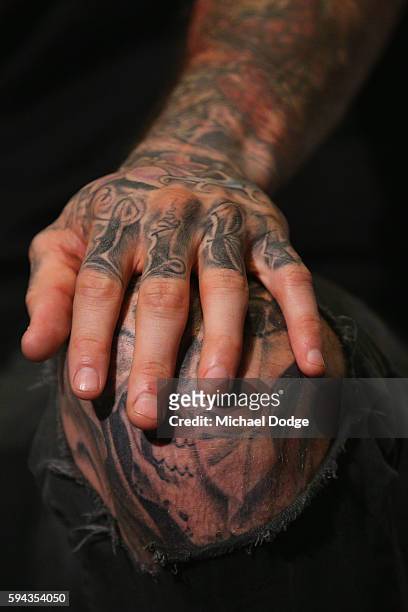 Retiring Dane Swan shpws off his tattoo during a Collingwood Magpies AFL media session at the Holden Centre on August 23, 2016 in Melbourne,...