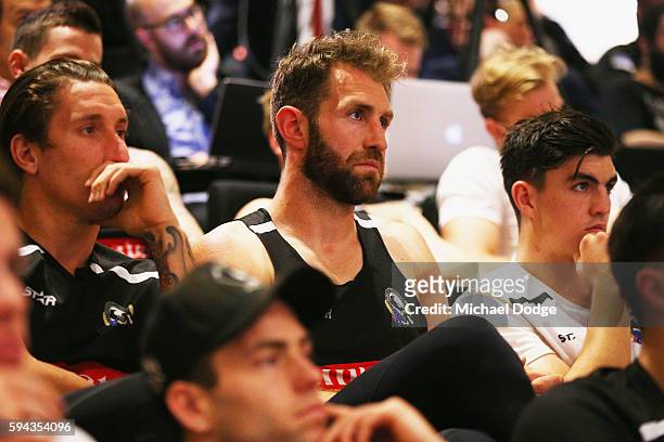 Travis Cloke looks on as retiring Dane Swan speaks during a Collingwood Magpies AFL media session at the Holden Centre on August 23, 2016 in...