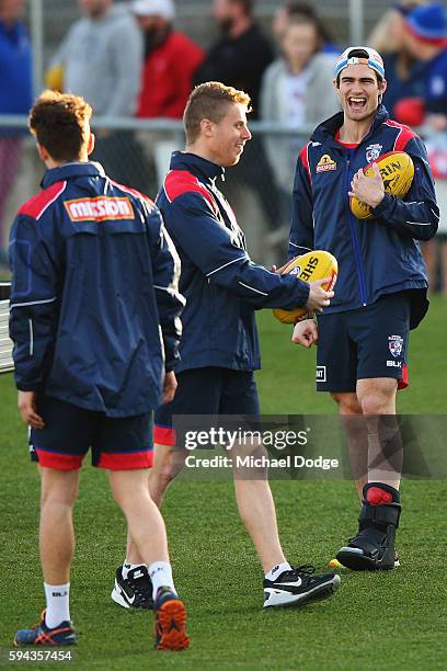 The injured Easton Wood of the Bulldogs reacts to Lachie Hunter during a Western Bulldogs AFL training session at Whitten Oval on August 23, 2016 in...