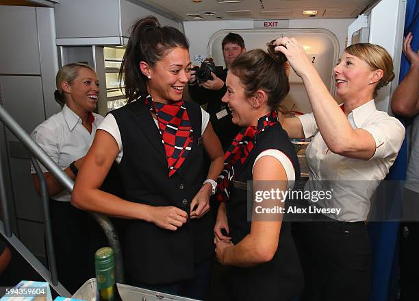 Sam Quek and Laura Unsworth of Great Britain dress up as cabin crew during the Team GB flight back from Rio on British Airways flight BA2016 on...