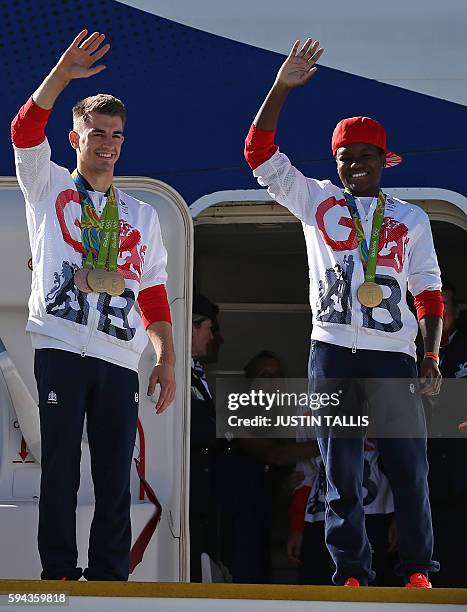 Britain's double gold medal winning gymnast Max Whitlock and Britain's gold medal winning boxer Nicola Adams wave from the top of the steps as...