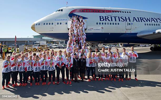 Members of the the British Olympic Team pose for a photograph with their medals after they arrive back from the Rio 2016 Olympic Games in Brazil on a...