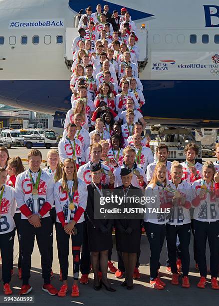 Members of the the British Olympic Team pose for a photograph with their medals after they arrive back from the Rio 2016 Olympic Games in Brazil, at...