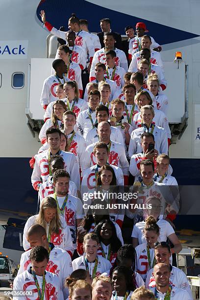 Members of the the British Olympic Team pose for a photograph with their medals after they arrive back from the Rio 2016 Olympic Games in Brazil, at...