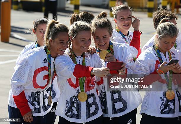 Members of the the British Olympic Team take photographs, with their medals after they arrive back from the Rio 2016 Olympic Games in Brazil, at...