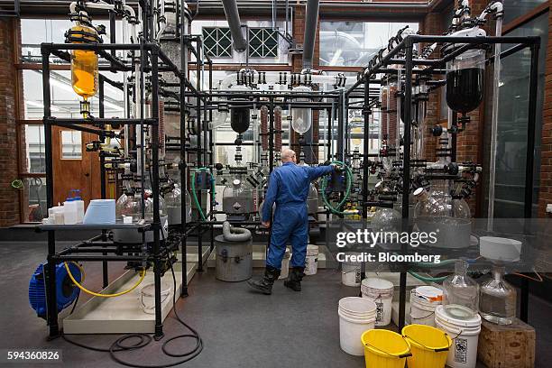 An employee checks on equipment used to separate gold from other metals at the Baird & Co. Ltd. Precious metals refinery in London, U.K., on...