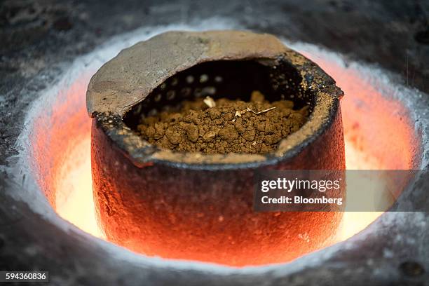 Gold grain is melted down to be set into a gold bar cast at the Baird & Co. Ltd. Precious metals refinery in London, U.K., on Wednesday, Aug. 3,...