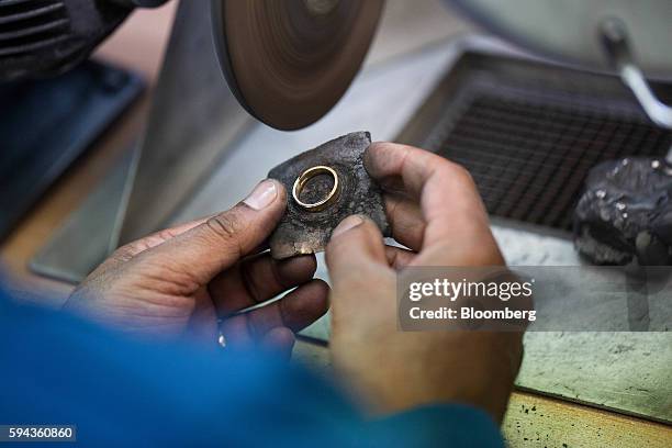 An employee polishes a wedding ring at Baird & Co. Ltd. Precious metals refinery in London, U.K., on Wednesday, Aug. 3, 2016. Baird & Co., which buys...