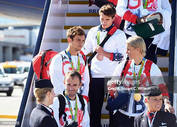 Divers Tom Daley and Daniel Goodfellow wear their bronze medals after arriving home at Heathrow Airport on August 23, 2016 in London, England. The...