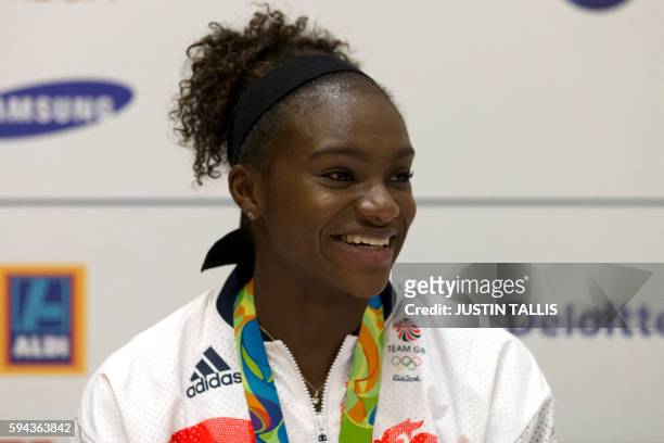 Britain's bronze medal winning sprinter Dina Asher-Smith speaks to members of the media at a press conference after arriving back from the Rio 2016...