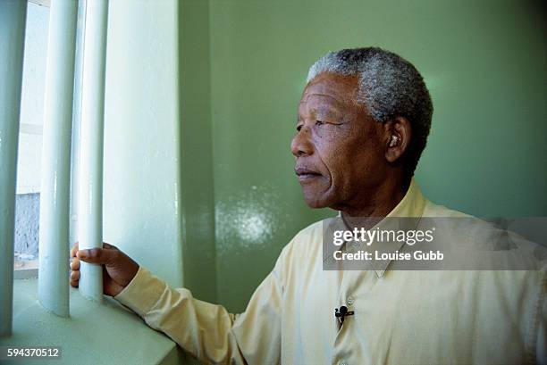 Nelson Mandela looks out the window of the cell in Robben Island Prison where he was incarcerated for more than two decades. He was held as a...