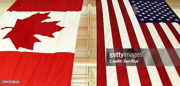 united states national flag and canadian flag ( maple leaf) hang side by side - mid atlantic bundesstaaten der usa stock-fotos und bilder