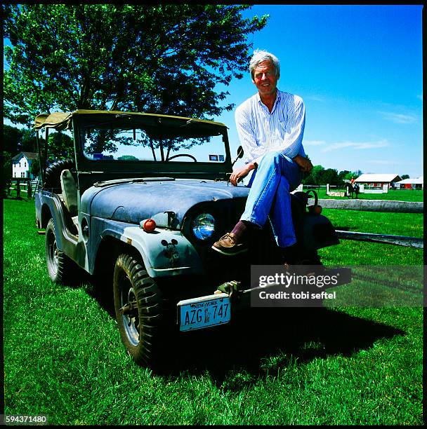 George Plimpton sitting on his Vietnam War era Jeep, East Hampton New York, On The Avenue magazine