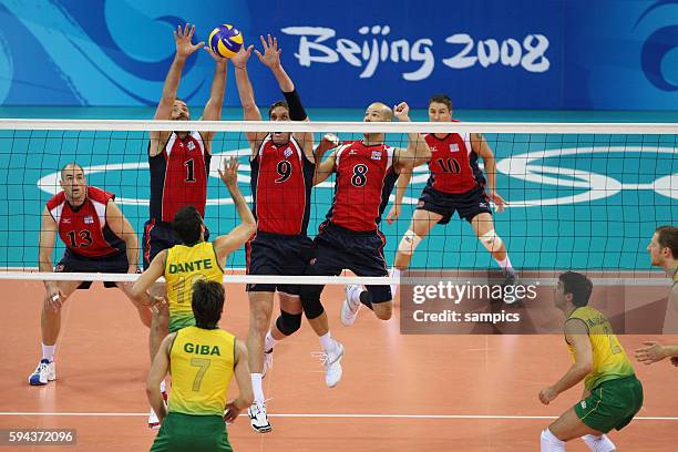 Clayton Stanley, Lloy Ball, Ryan Millar of the USA blocking against Brazil's Dante during the Men's Volleyball final between USa and Brazil during...