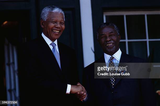 South African President Nelson Mandela shakes hands with future president Thabo Mbeki after the opening of Parliament in Cape Town.