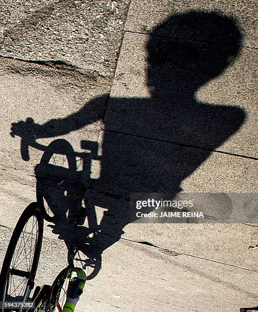 The shadow of Tinkoff's Spanish cyclist Alberto Contador is projected on the ground before start the fourth stage of the 71st edition of "La Vuelta"...