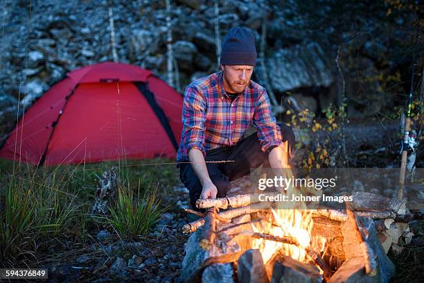 man having campfire - dalsland stock pictures, royalty-free photos & images