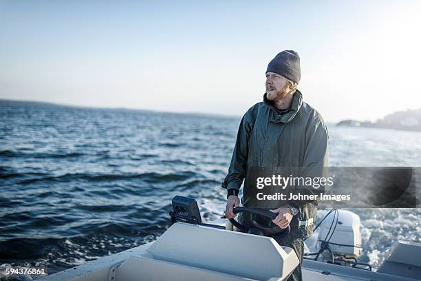 fisherman on boat - motor boats stock pictures, royalty-free photos & images