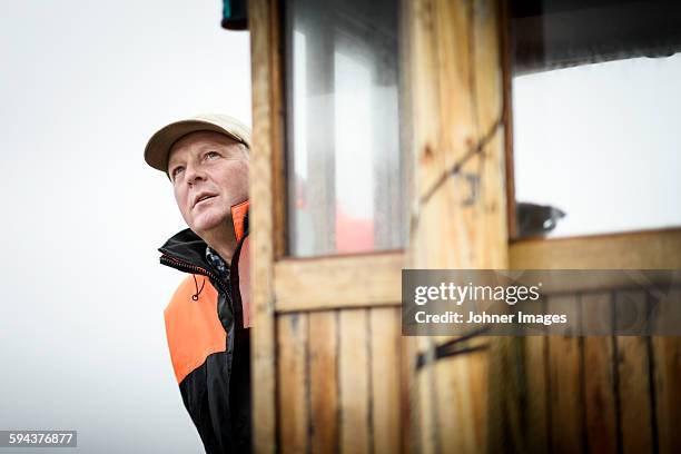 man on boat looking away - grebbestad stockfoto's en -beelden