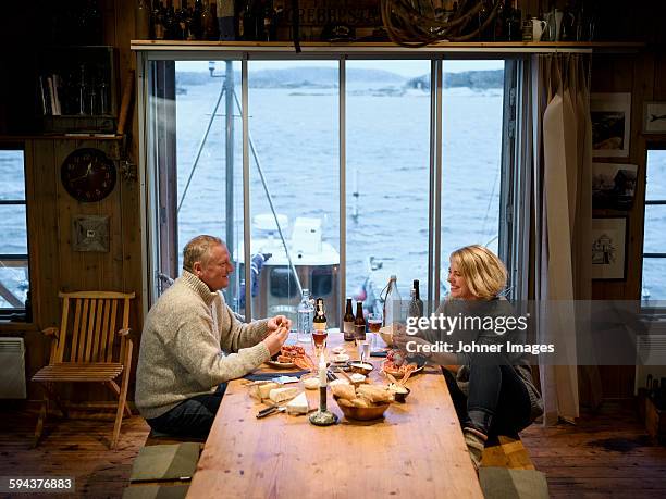 mature couple having meal - grebbestad stockfoto's en -beelden