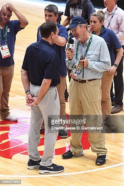 Mike Krzyzewski of the USA Basketball Men's National Team speaks during an interview with P.J. Carlesimo at practice during the Rio 2016 Olympic...