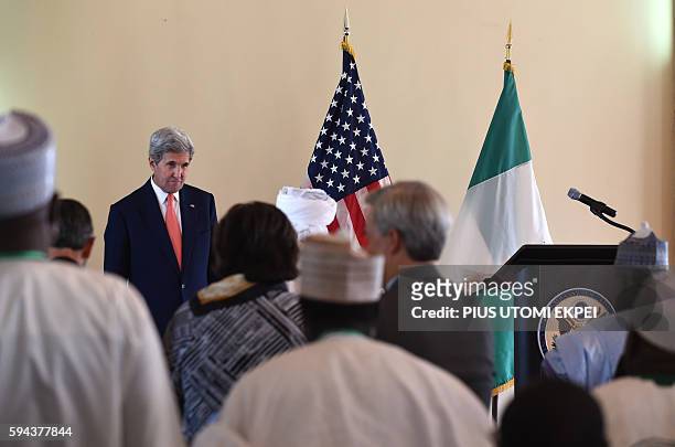 Secretary of State John Kerry stands as he delivers a speech on "the importance of resilient communities and religious tolerance in countering...