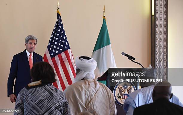 Secretary of State John Kerry stands as he delivers a speech on "the importance of resilient communities and religious tolerance in countering...