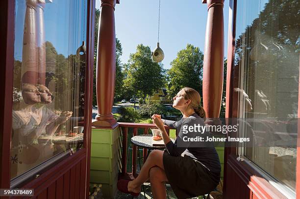 woman relaxing on balcony - johner images bildbanksfoton och bilder