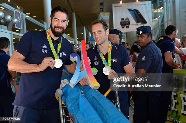 Nikola Karabatic, handball silver medalist, and Renaud Lavillenie, pole vault silver medalist, arrive at Roissy Charles de Gaulle airport after the...