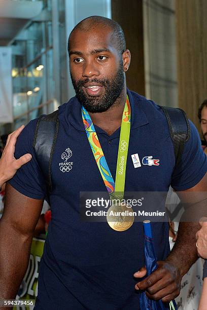 Teddy Riner, over 100 kg judo gold medalist, arrives at Roissy Charles de Gaulle airport after the Olympic Games in Rio on August 23, 2016 in Paris,...