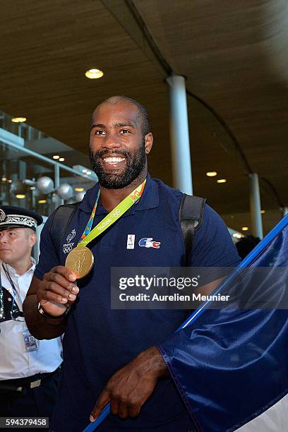 Teddy Riner, over 100 kg judo gold medalist, arrives at Roissy Charles de Gaulle airport after the Olympic Games in Rio on August 23, 2016 in Paris,...